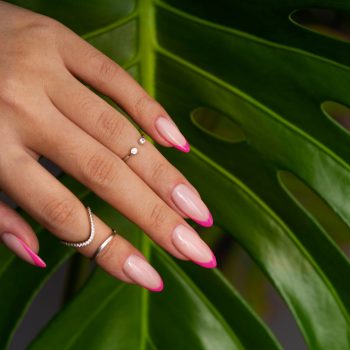 woman-showing-her-nail-art-fingernails-against-monster-leaf