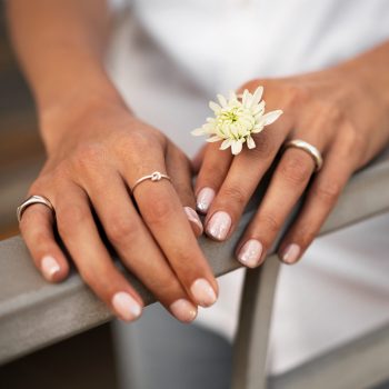 woman-showing-her-nail-art-fingernails-with-flower
